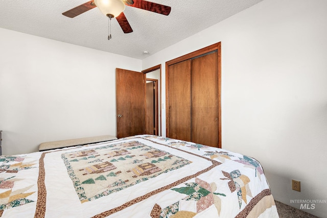 bedroom featuring ceiling fan, a closet, and a textured ceiling