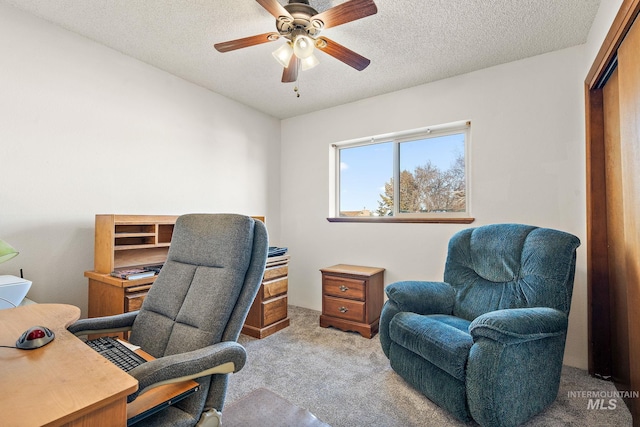 office with ceiling fan, light carpet, and a textured ceiling