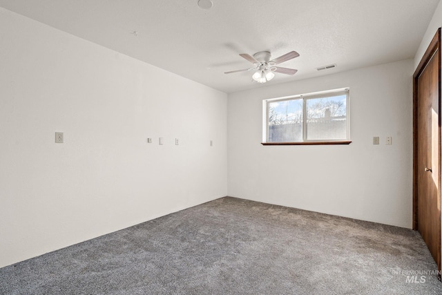 carpeted empty room featuring ceiling fan