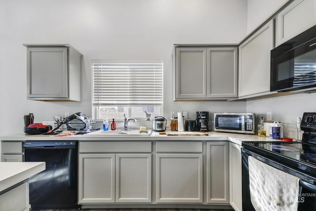 kitchen featuring sink, gray cabinets, and black appliances