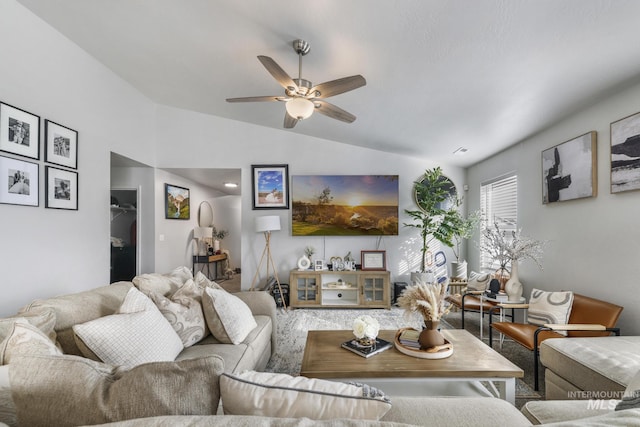 living room with ceiling fan and vaulted ceiling