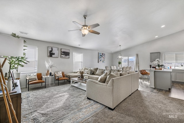 living room with sink, dark wood-type flooring, vaulted ceiling, and ceiling fan