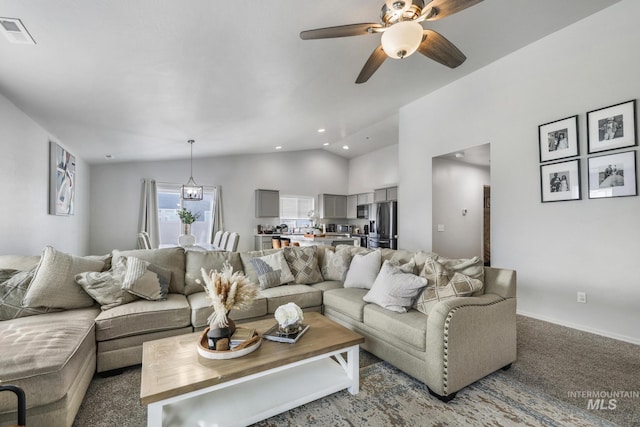 living room featuring lofted ceiling, carpet flooring, and ceiling fan