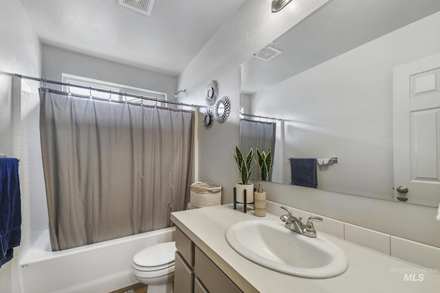 full bathroom with shower / bath combo with shower curtain, vanity, and toilet