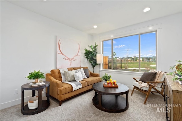 carpeted living area with recessed lighting and baseboards