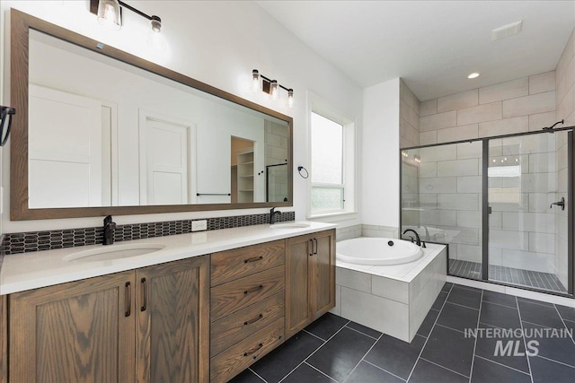 bathroom with tile patterned floors, separate shower and tub, and vanity