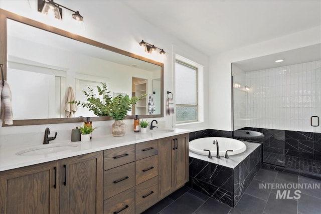 full bathroom featuring a garden tub, a sink, tile patterned floors, double vanity, and a stall shower