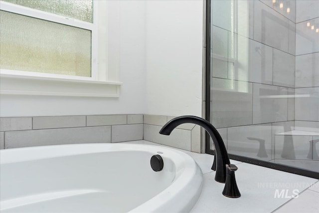 bathroom featuring a tub and plenty of natural light