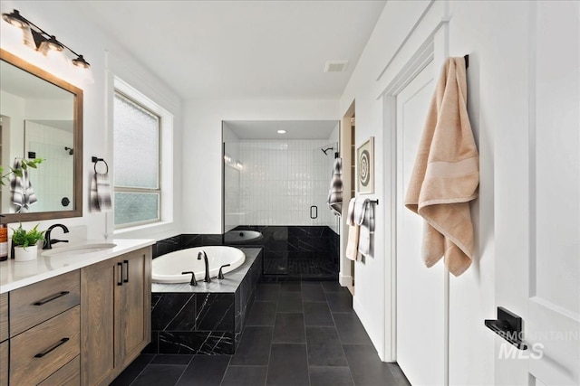 full bath featuring a stall shower, visible vents, tile patterned flooring, vanity, and a bath