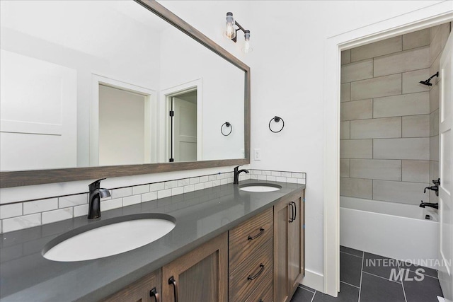 bathroom featuring decorative backsplash, vanity, tile patterned floors, and tiled shower / bath combo