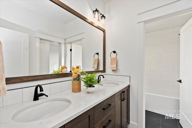 full bathroom with tile patterned floors, a sink, and double vanity