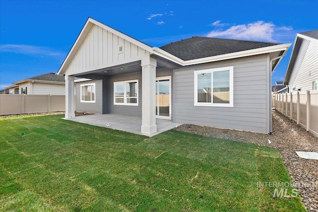 back of property featuring a patio and a lawn