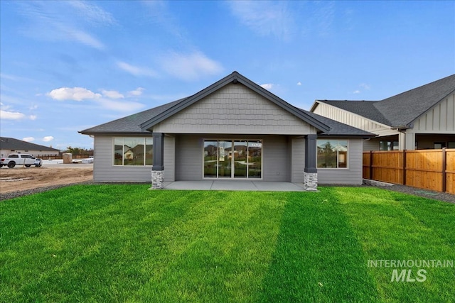 back of house featuring fence, a patio, and a yard