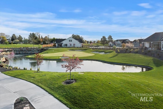 view of community featuring a lawn and a water view