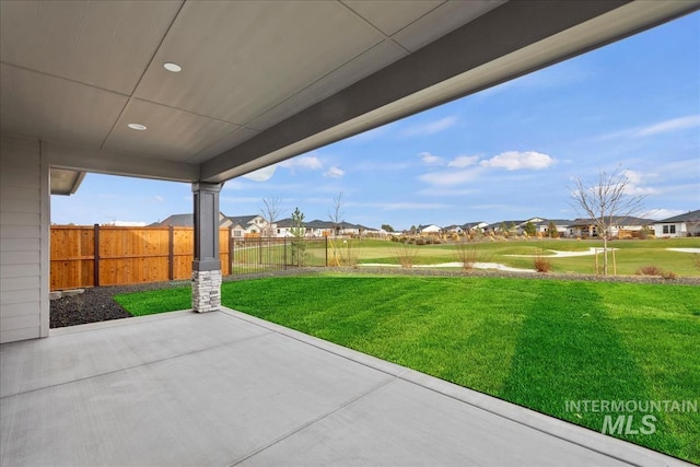 view of patio / terrace featuring fence and a residential view