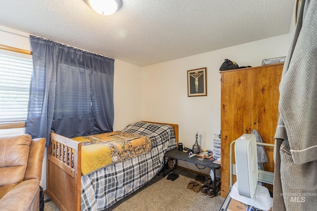 bedroom with carpet flooring and a textured ceiling