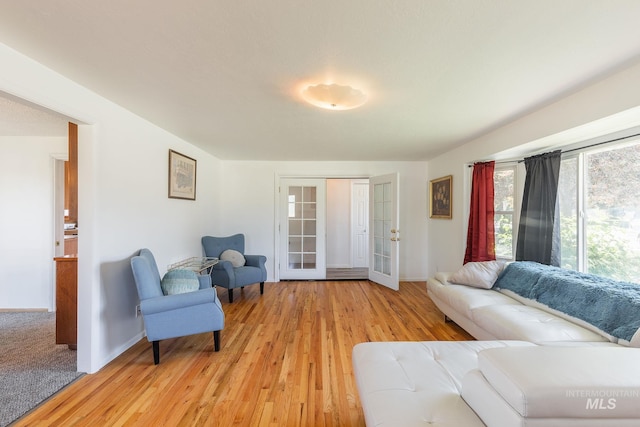 living room with french doors and light hardwood / wood-style flooring