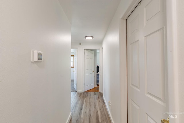 hall with light hardwood / wood-style floors