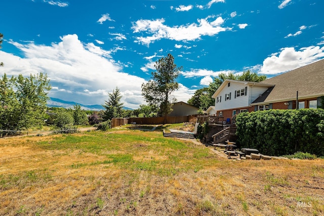 view of yard featuring a deck with mountain view