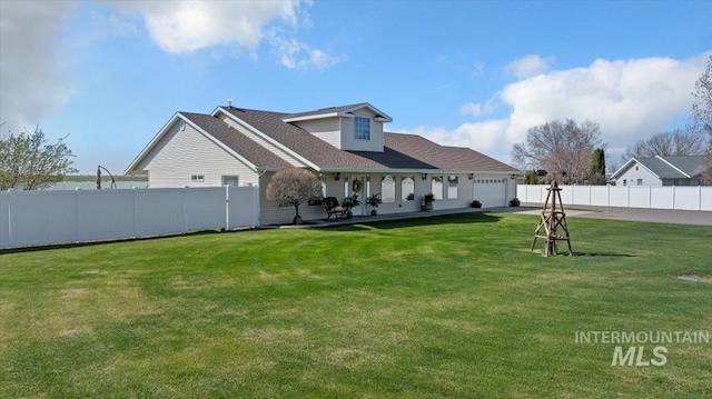 323 W 100 N, Jerome, ID 83338 - rear view of house with a yard, fence, and an attached garage