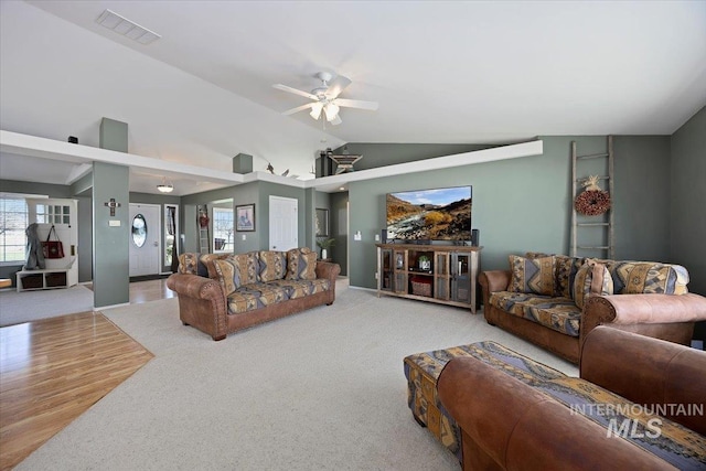 323 W 100 N, Jerome, ID 83338 - living area with lofted ceiling, carpet flooring, visible vents, ceiling fan, and wood finished floors