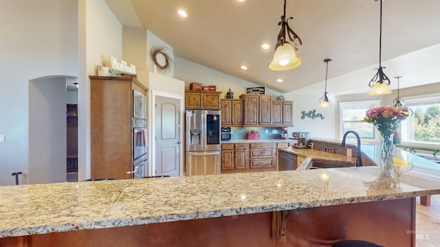 3634 E 3892 N, Kimberly, ID 83341 - kitchen with appliances with stainless steel finishes, a sink, vaulted ceiling, light stone counters, and brown cabinets