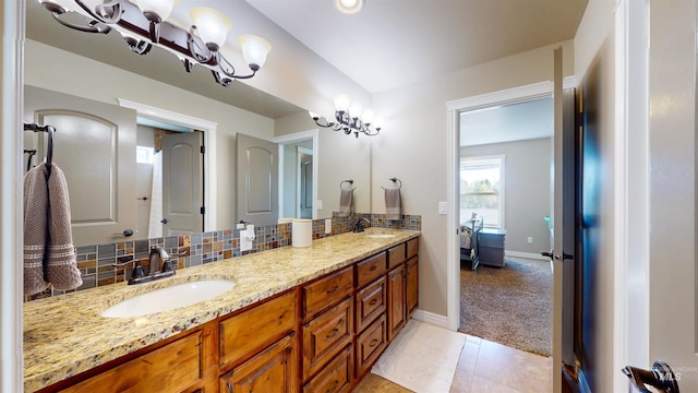 3634 E 3892 N, Kimberly, ID 83341 - bathroom featuring double vanity, baseboards, backsplash, and tile patterned floors