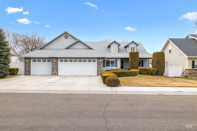 view of front of house featuring a garage and a front lawn