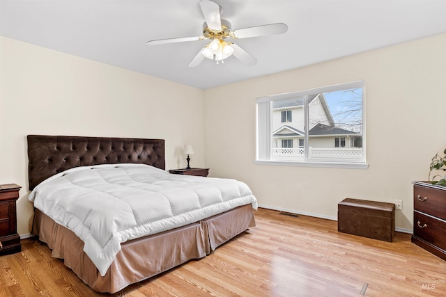 bedroom with ceiling fan and light hardwood / wood-style flooring