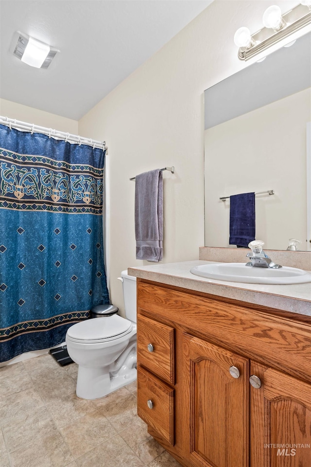 bathroom with toilet and vanity