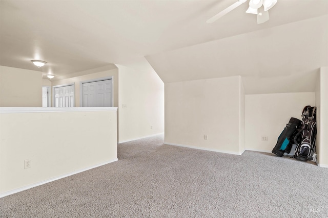 additional living space with lofted ceiling, ceiling fan, and light colored carpet