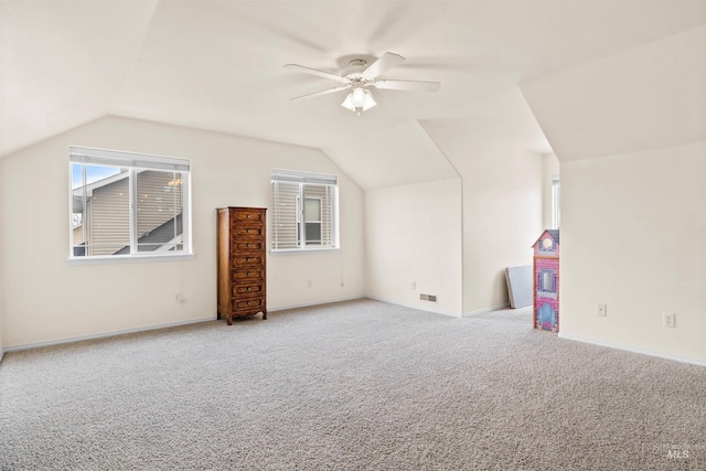 additional living space with lofted ceiling, ceiling fan, and carpet