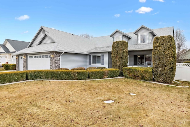 view of front of property featuring a front yard and a garage