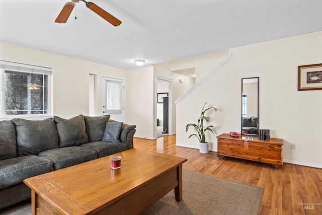 living room featuring ceiling fan and light hardwood / wood-style floors