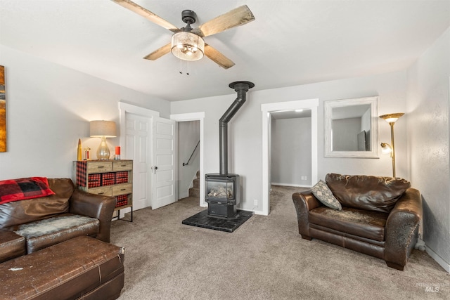 1035 Francis St, Clarkston, WA 99403 - carpeted living area featuring a wood stove and ceiling fan