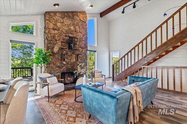 1909 E Roanoke Dr, Boise, ID 83712 - living area with high vaulted ceiling, wood finished floors, a stone fireplace, stairs, and wood walls