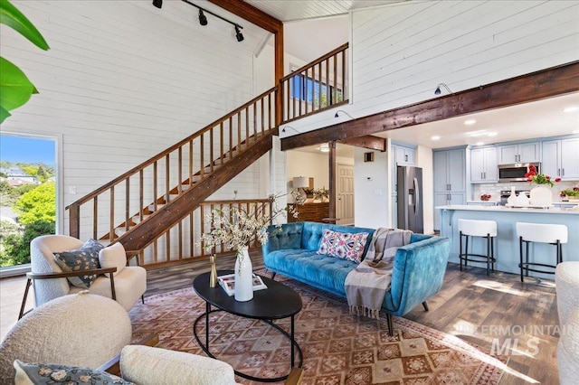 1909 E Roanoke Dr, Boise, ID 83712 - living area featuring high vaulted ceiling, stairs, dark wood-style floors, beam ceiling, and rail lighting