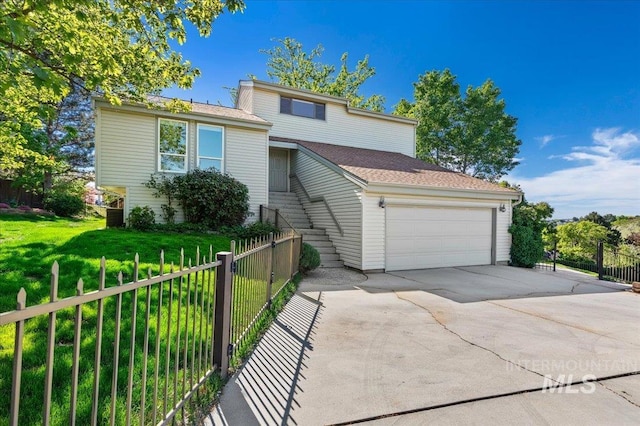 1909 E Roanoke Dr, Boise, ID 83712 - tri-level home with an attached garage and concrete driveway