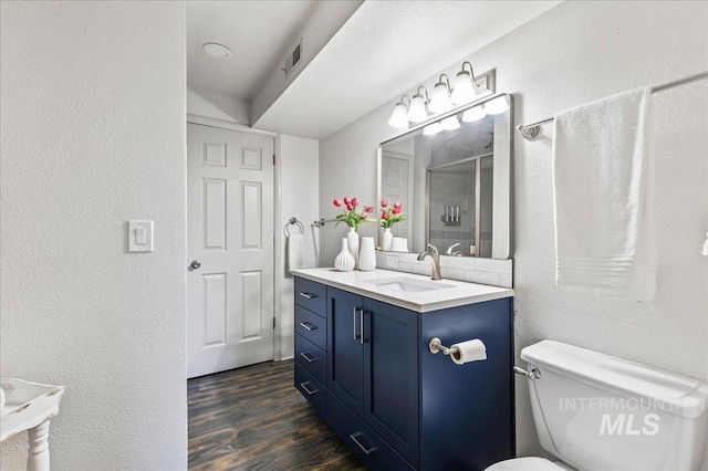 1909 E Roanoke Dr, Boise, ID 83712 - full bath featuring a textured wall, a shower stall, wood finished floors, toilet, and vanity