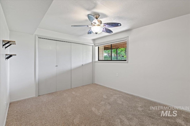 1909 E Roanoke Dr, Boise, ID 83712 - unfurnished bedroom featuring carpet, a closet, a textured ceiling, and ceiling fan
