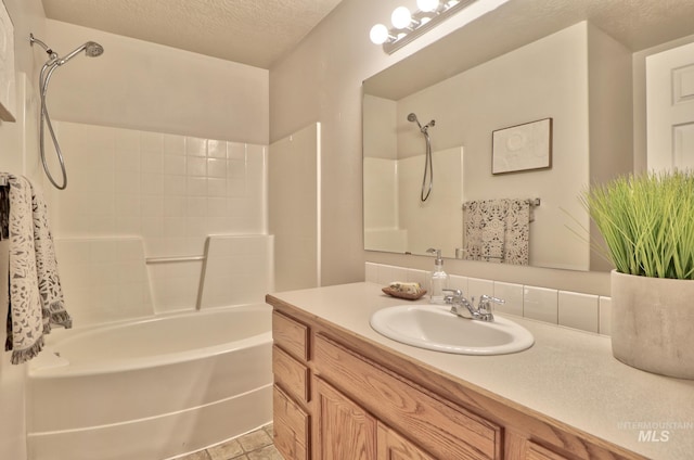 full bath with vanity, tub / shower combination, and a textured ceiling