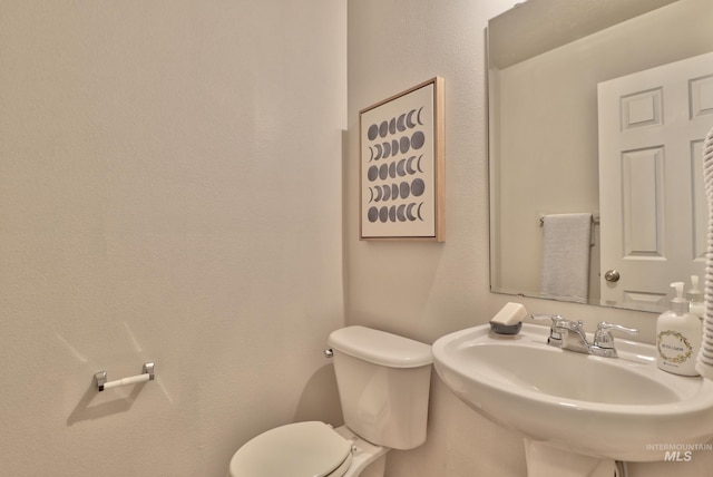 bathroom with toilet and a sink