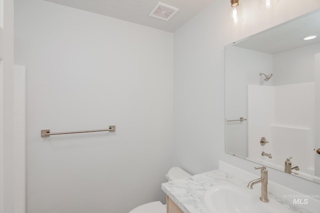 bathroom featuring a shower, vanity, and toilet