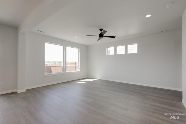 6847 W Riverwood St, Boise, ID 83709 - empty room featuring ceiling fan, wood finished floors, and baseboards