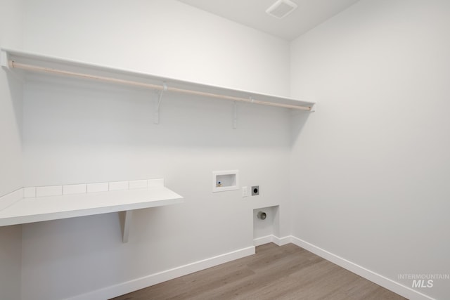 6847 W Riverwood St, Boise, ID 83709 - washroom featuring hookup for a washing machine, wood finished floors, laundry area, hookup for an electric dryer, and baseboards