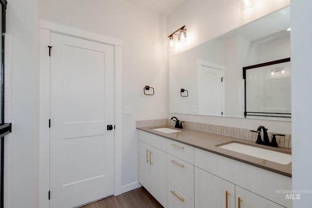 6847 W Riverwood St, Boise, ID 83709 - bathroom with wood finished floors, double vanity, and a sink