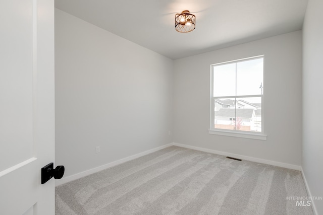 6847 W Riverwood St, Boise, ID 83709 - spare room with baseboards, visible vents, and light colored carpet
