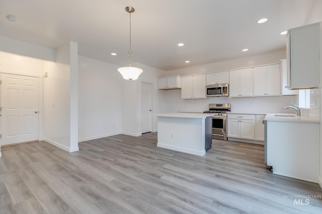 6847 W Riverwood St, Boise, ID 83709 - kitchen with recessed lighting, stainless steel appliances, light wood-style floors, and a sink