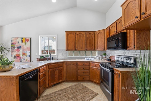 kitchen featuring black appliances, brown cabinets, a sink, and light countertops