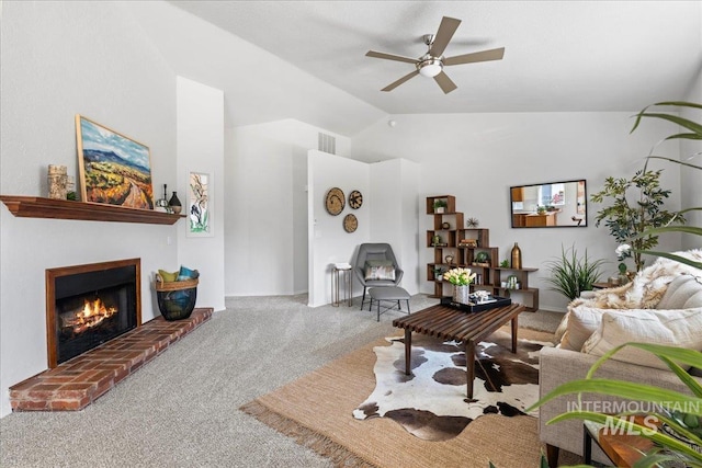 living room with carpet, lofted ceiling, visible vents, a brick fireplace, and ceiling fan